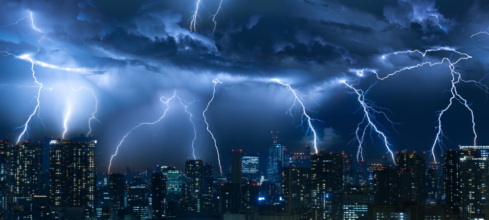 Lightning storm over city in blue light
