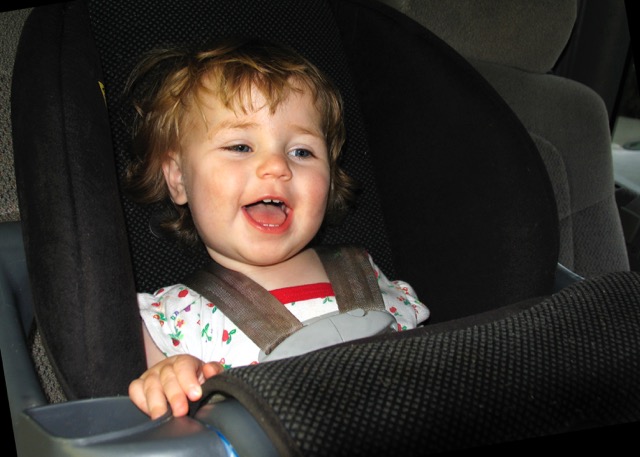 Child in car seat at Christmas Christmas Cleaning Tips