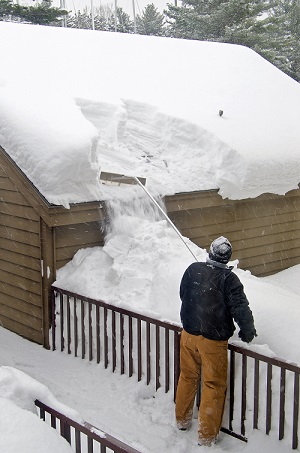 man using a snow rake