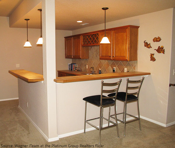 An impressibe backsplash enhances the appeal of a home bar.