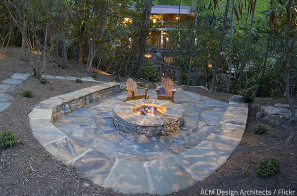Stone patio designs with fire pit provide a way to enjoy nature within the comfort of your home.