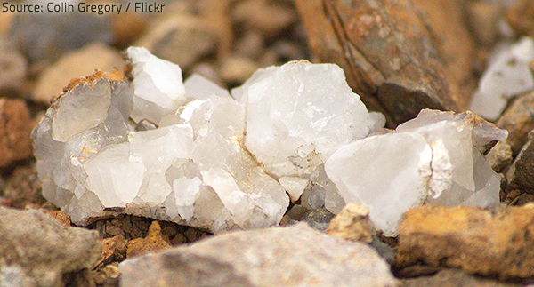 Natural quartz granules are combined with a binder and a colorant to create durable, non-porous quartz surfaces.