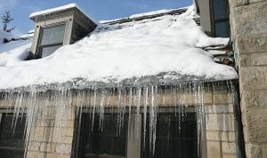 snow and icicles on roof Ice-Dams-Removal-Tips