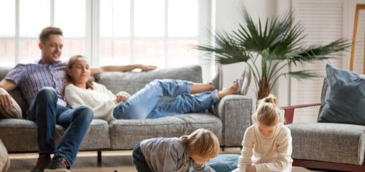 Children Playing While Parents Watch Sitting on the Couch