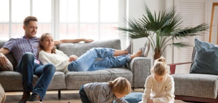 Children Playing While Parents Watch Sitting on the Couch