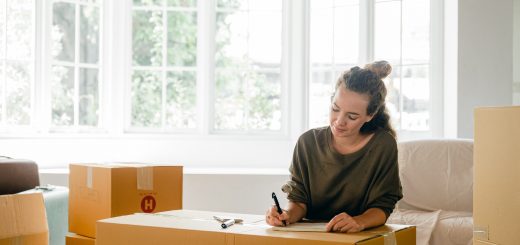 Young Woman Labeling Boxes