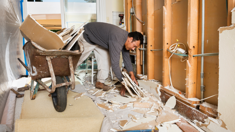 Construction worker cleaning up