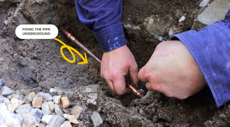 A Plumber Fixing an Underground Water Pipe