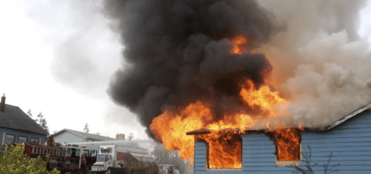 house with fire and smoke in a neighborhood