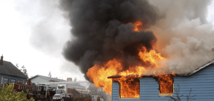 house with fire and smoke in a neighborhood