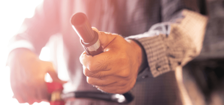 man showing fire extinguisher nozzle