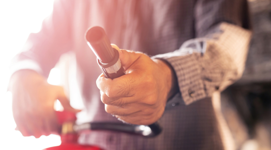 man showing fire extinguisher nozzle man showing fire extinguisher nozzle