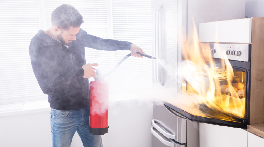man using fire extinguisher to put out a fire man using fire extinguisher to put out a fire