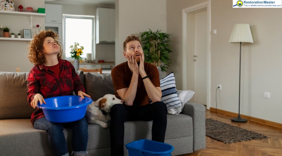 a man and woman shocked to see the ceiling leak a man and woman shocked to see the ceiling leak